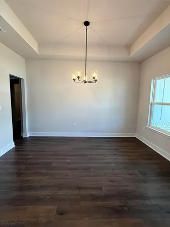 a view of a room with wooden floor and window