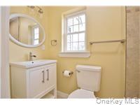 162 Rockland Road Roscoe, NY 12776 - Photo 17 of 36 a bathroom with a sink a toilet and a mirror