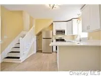 a kitchen with a refrigerator and a sink