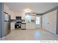 162 Rockland Road Roscoe, NY 12776 - Photo 24 of 36 a kitchen with a refrigerator and a sink