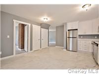 162 Rockland Road Roscoe, NY 12776 - Photo 25 of 36 a view of a kitchen with a refrigerator wooden cabinets