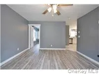 a view of an empty room and wooden floor