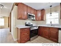 a kitchen with stainless steel appliances granite countertop a stove a sink dishwasher and a microwave oven with cabinets