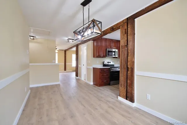 a view of a kitchen with a sink and a refrigerator