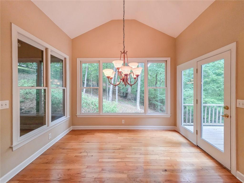 3712 Frederica Road Northwest Berkeley Lake, GA 30096 - Photo 15 of 49 a view of an empty room with wooden floor and a window
