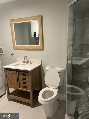 a bathroom with a sink toilet and mirror