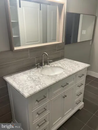 a bathroom with a sink vanity and granite