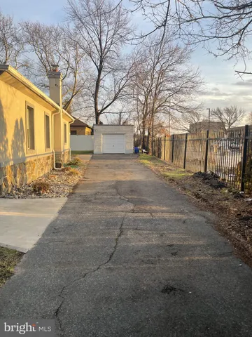 a dirt road with trees in front of it