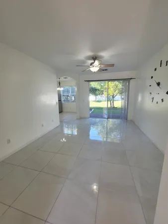an empty room with stairs and windows