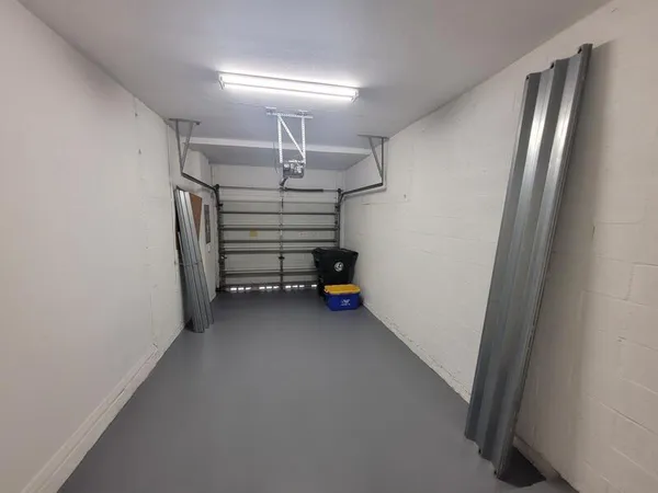 an empty room with windows and fan view