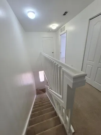an aerial view of a house with garden space and street view