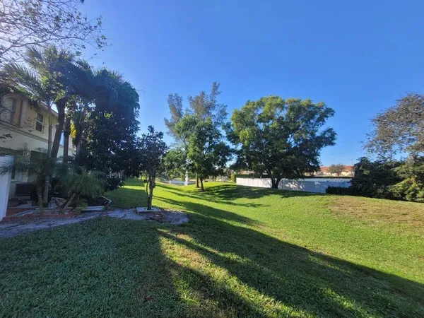 an aerial view of a house with yard swimming pool and outdoor seating