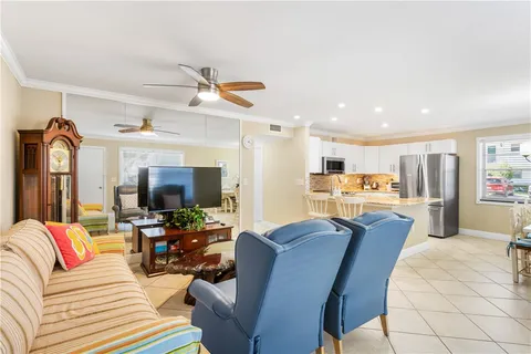 a living room with furniture and kitchen view
