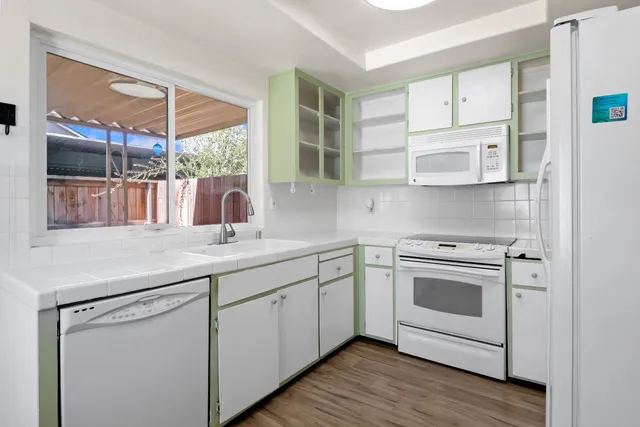 a kitchen with stainless steel appliances granite countertop a sink and a microwave