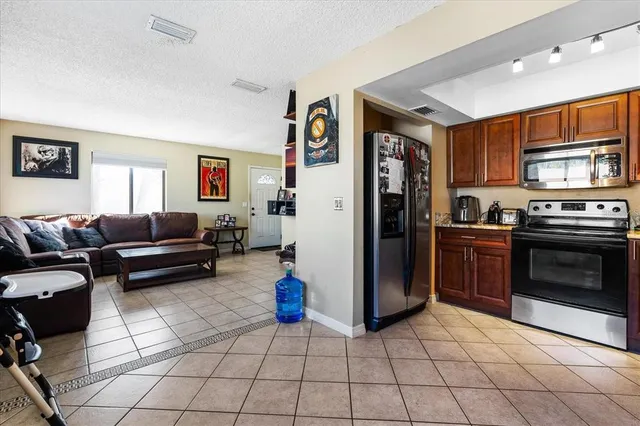 a kitchen with stainless steel appliances granite countertop wooden cabinets a stove top oven a sink and dishwasher