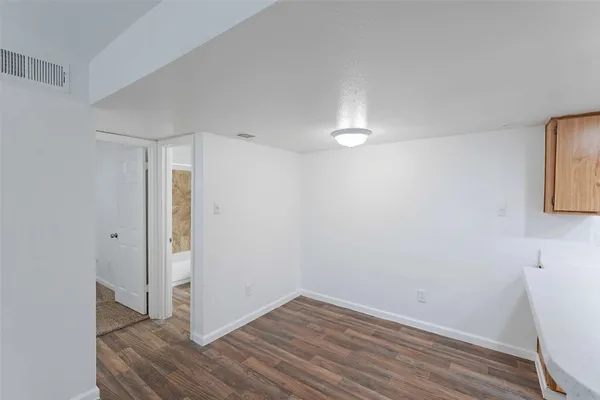 a view of hallway with wooden floor