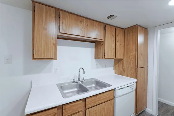 a kitchen with a sink cabinets and stainless steel appliances