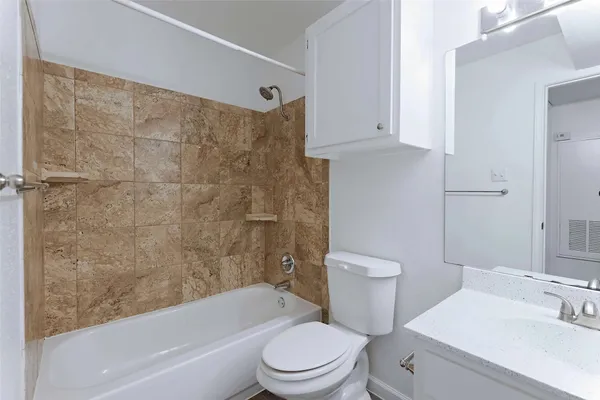 a bathroom with a toilet a sink and bathtub