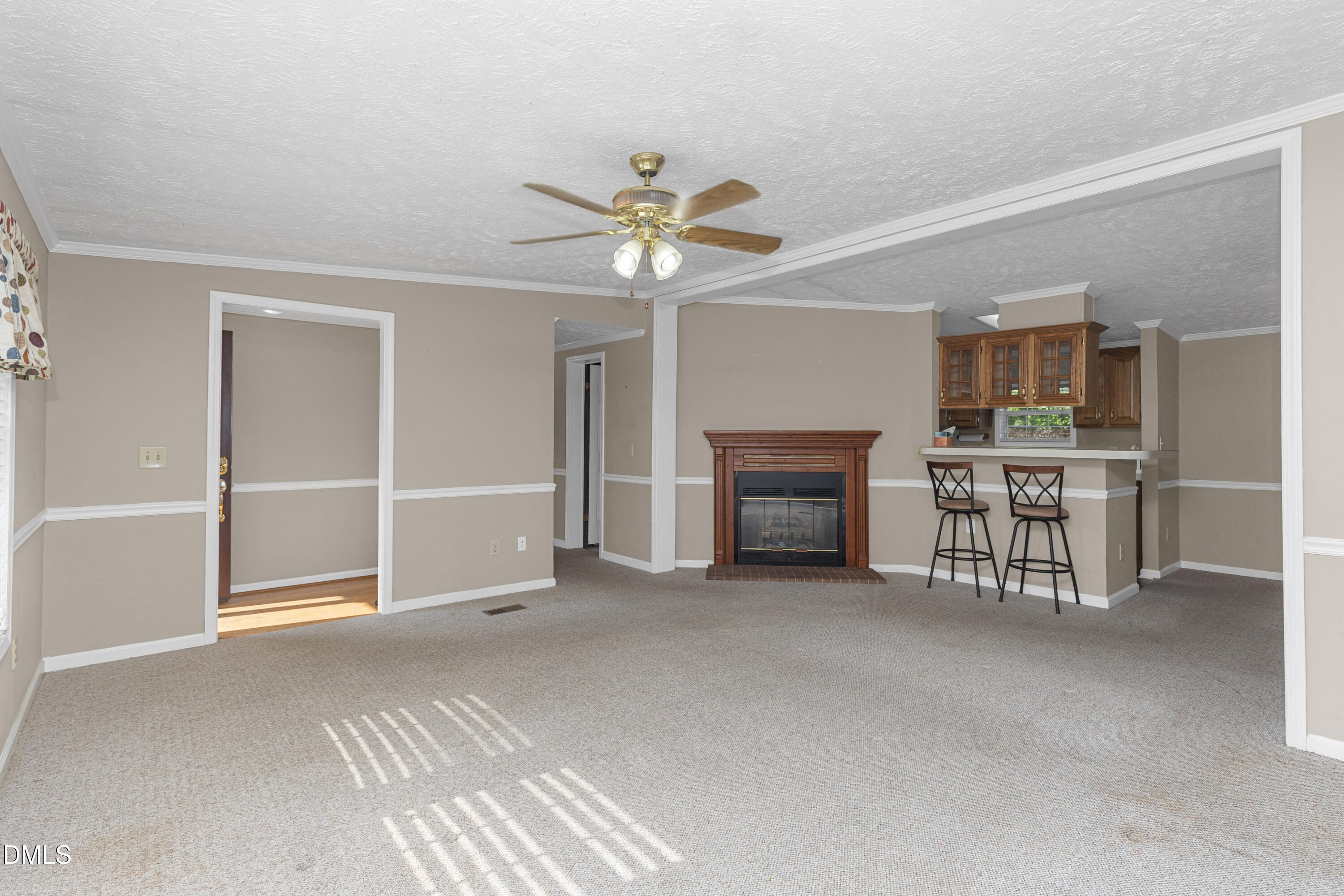 199 Iris Bryant Road Erwin, NC 28339 - Photo 6 of 33 a view of an empty room with a fireplace and a chandelier fan