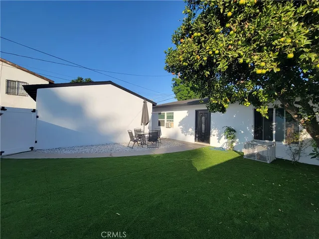 a house view with a sitting space and garden