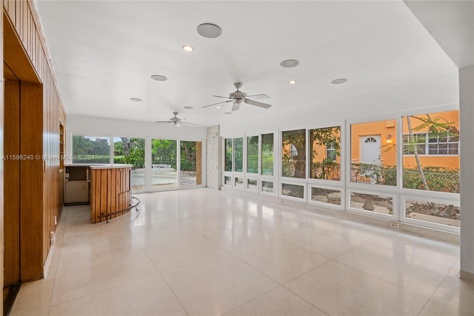 5311 Alton Road Miami Beach, FL 33140 - Photo 13 of 51 a view of an empty room with a sliding door and city view