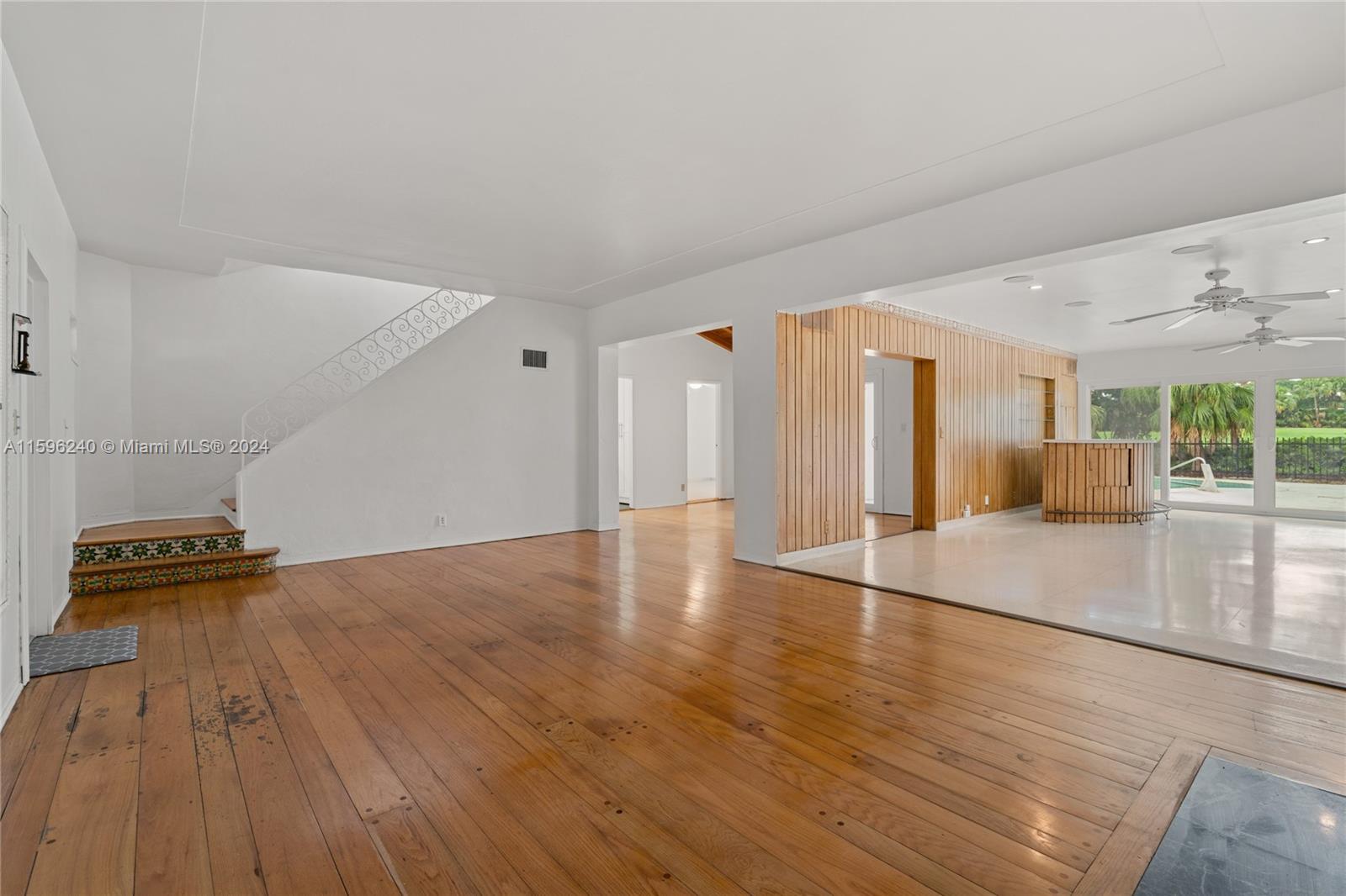 5311 Alton Road Miami Beach, FL 33140 - Photo 15 of 51 a view of an empty room with wooden floor and a window