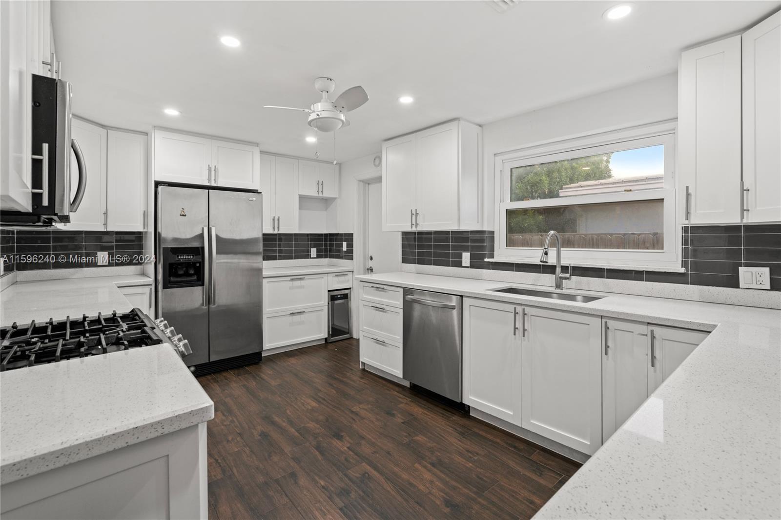 5311 Alton Road Miami Beach, FL 33140 - Photo 17 of 51 a kitchen with white cabinets and appliances