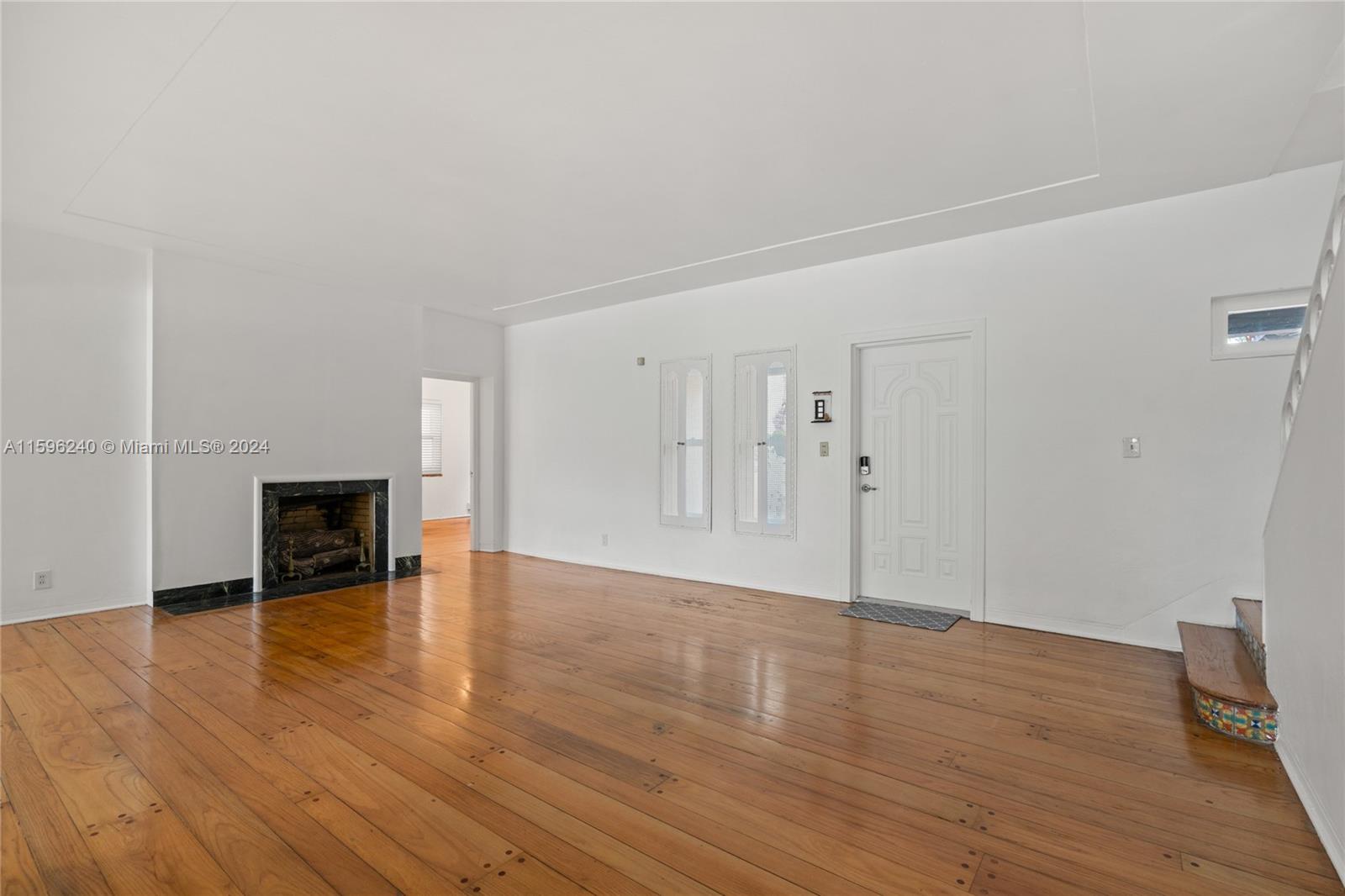 5311 Alton Road Miami Beach, FL 33140 - Photo 31 of 51 a view of a livingroom with wooden floor and a fireplace