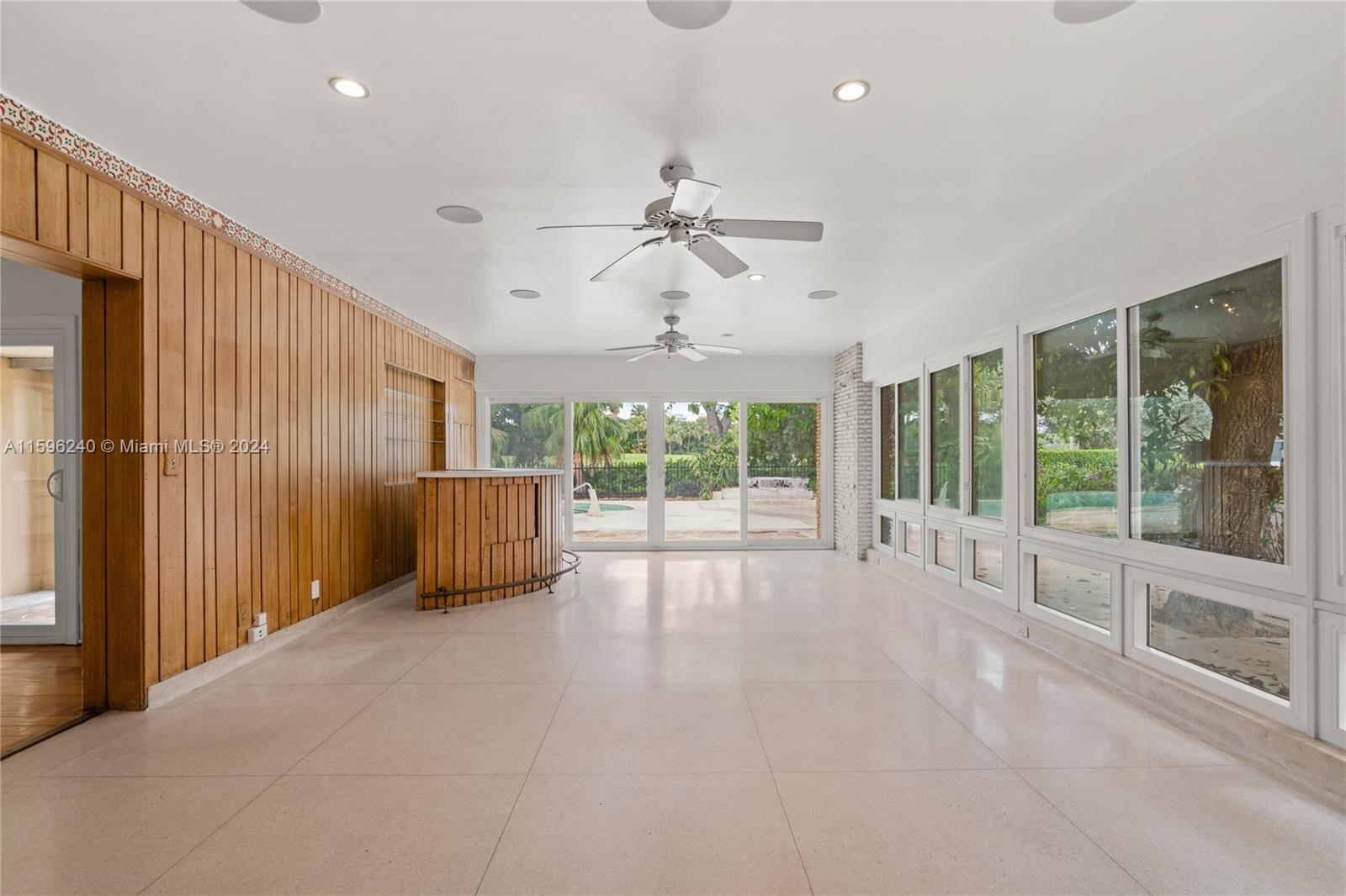 5311 Alton Road Miami Beach, FL 33140 - Photo 33 of 51 a view of an empty room with a fireplace and large windows