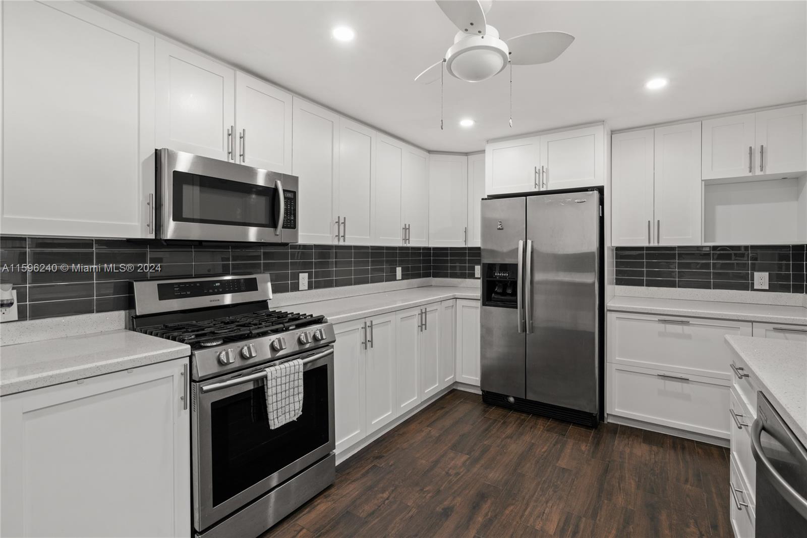 5311 Alton Road Miami Beach, FL 33140 - Photo 35 of 51 a kitchen with stainless steel appliances a refrigerator stove and microwave
