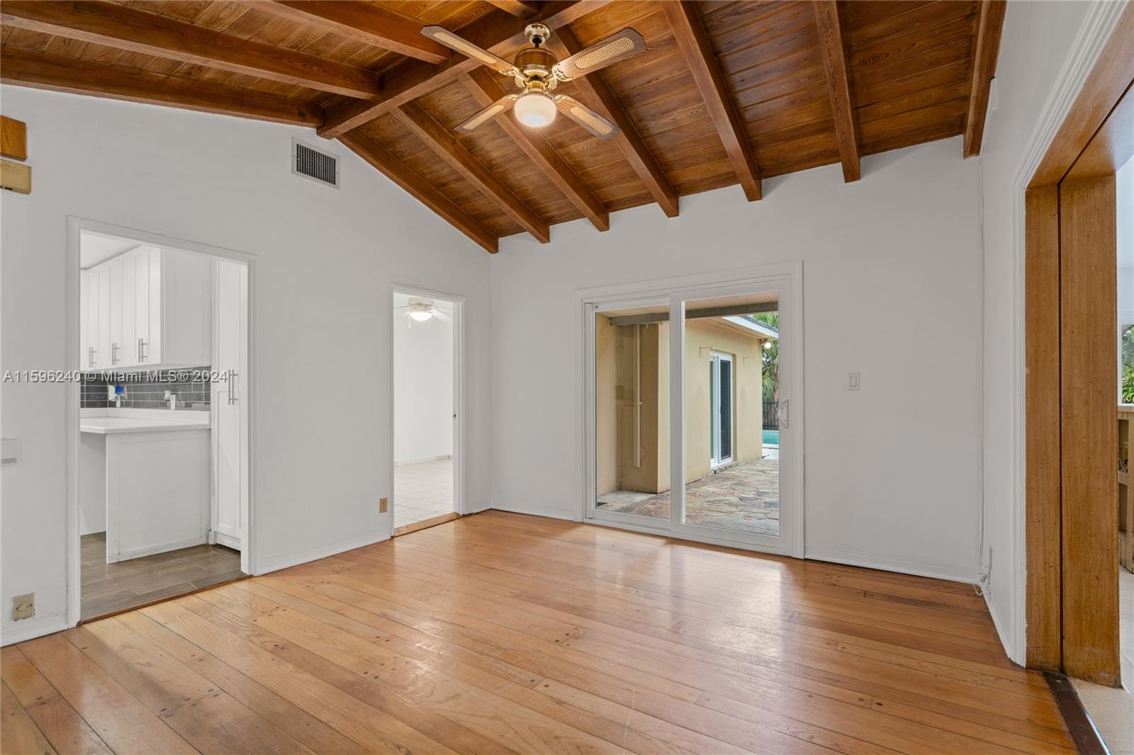 5311 Alton Road Miami Beach, FL 33140 - Photo 37 of 51 a view of a big room with wooden floor and windows
