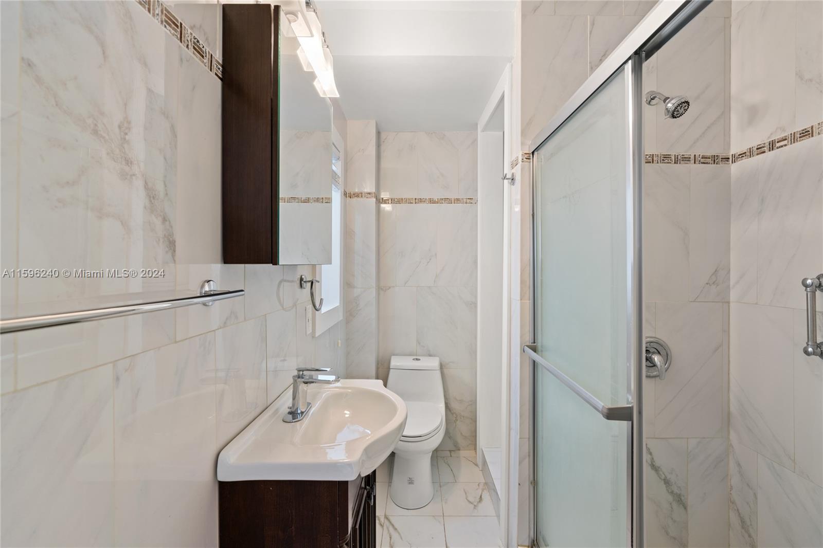 5311 Alton Road Miami Beach, FL 33140 - Photo 44 of 51 a bathroom with a sink and a mirror