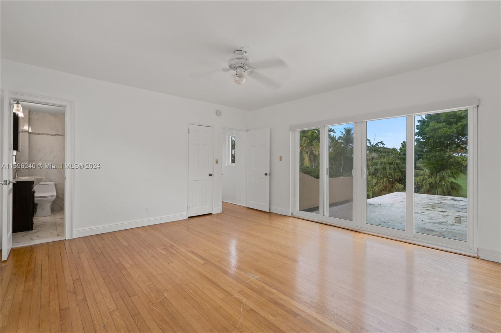 5311 Alton Road Miami Beach, FL 33140 - Photo 46 of 51 a view of an empty room with a window and wooden floor