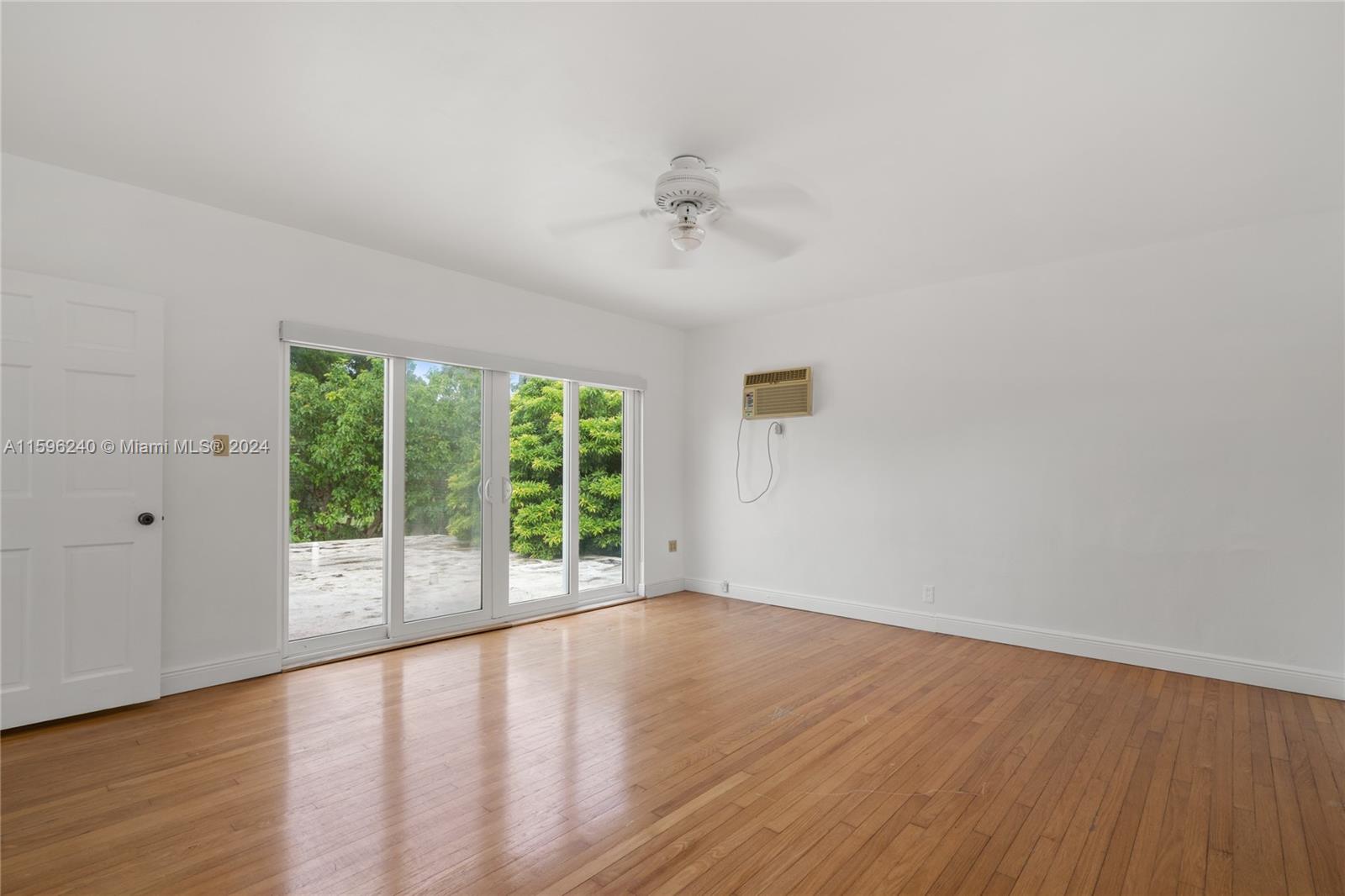 5311 Alton Road Miami Beach, FL 33140 - Photo 47 of 51 wooden floor in an empty room with a window