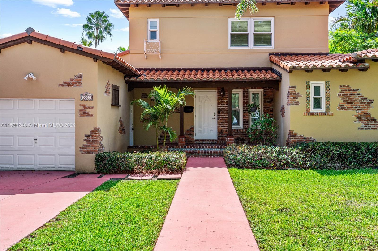 5311 Alton Road Miami Beach, FL 33140 - Photo 6 of 51 a front view of a house with a yard and potted plants