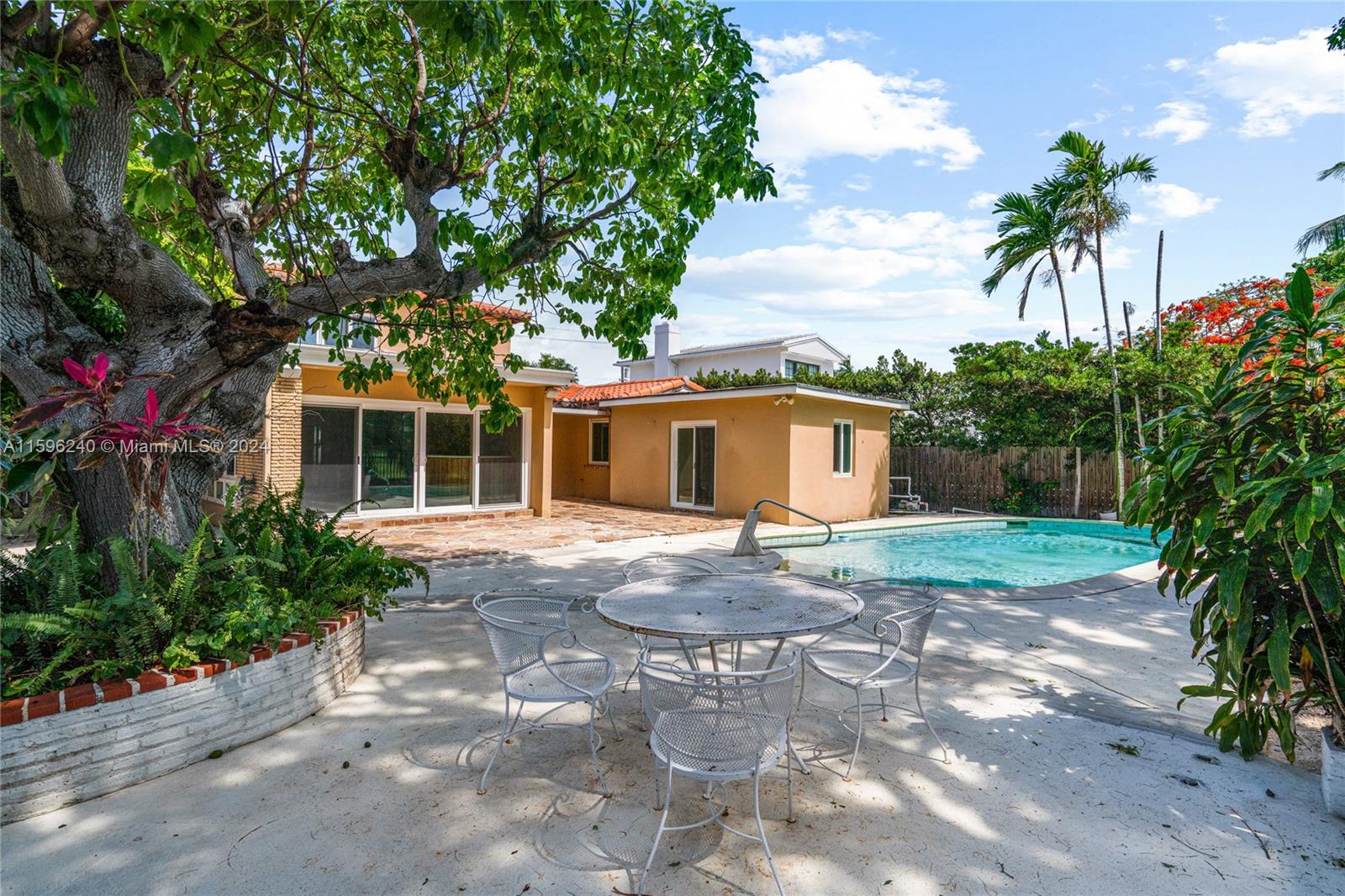 5311 Alton Road Miami Beach, FL 33140 - Photo 9 of 51 a front view of a house with a yard and a garage