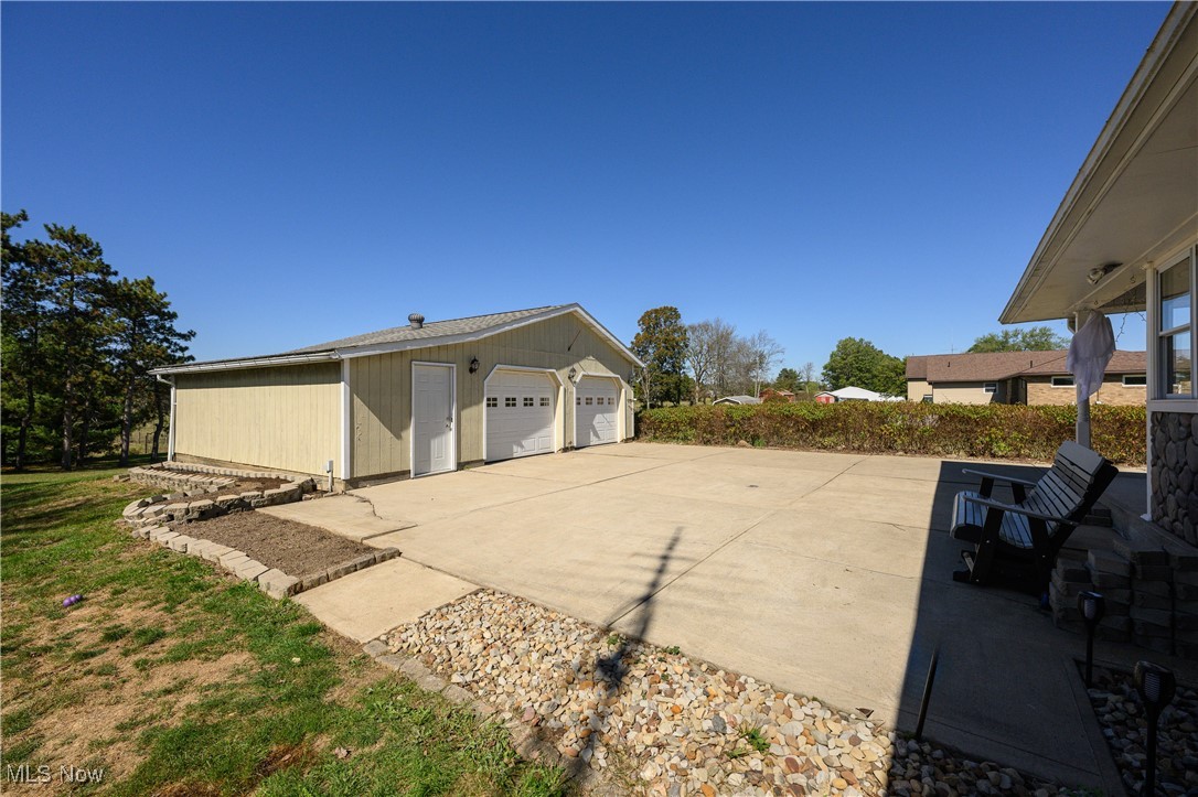 View of patio with a garage