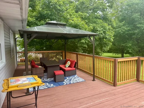 a backyard of a house with fountain table and chairs