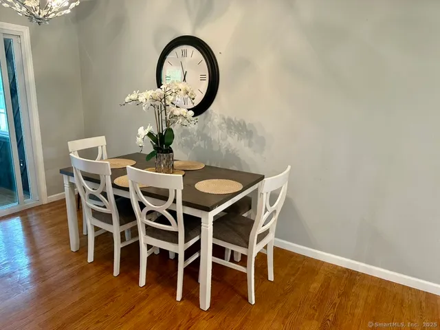 a dining room with furniture and wooden floor