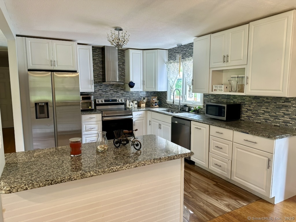 660 East Street South Suffield, CT 06078 - Photo 14 of 39 a kitchen with a refrigerator stove top oven and sink