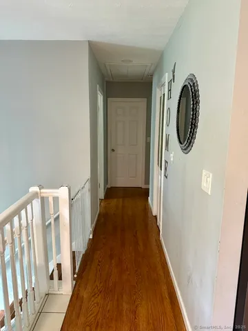 a view of a hallway with wooden floor