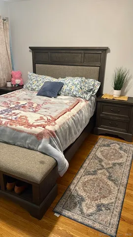 a bedroom with a bed and a couch