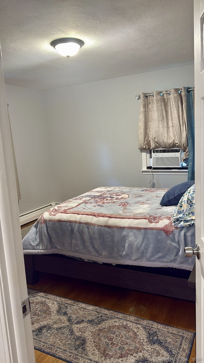 660 East Street South Suffield, CT 06078 - Photo 26 of 39 a bedroom with a bed and painting on the wall