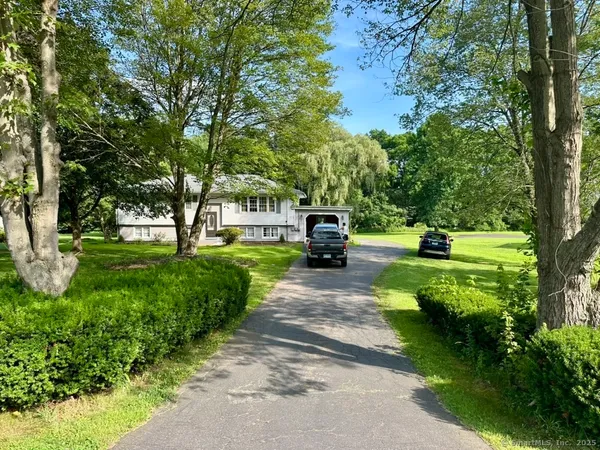a view of a street with a car parked on the side of it