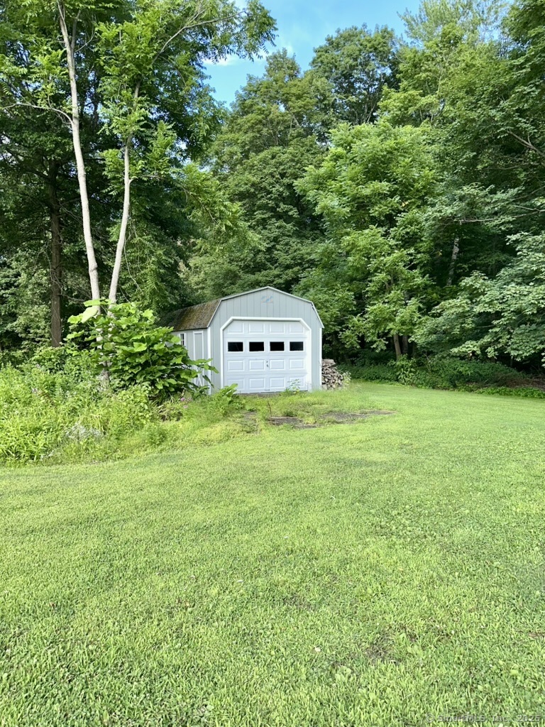 660 East Street South Suffield, CT 06078 - Photo 7 of 39 a view of a backyard with a small cabin