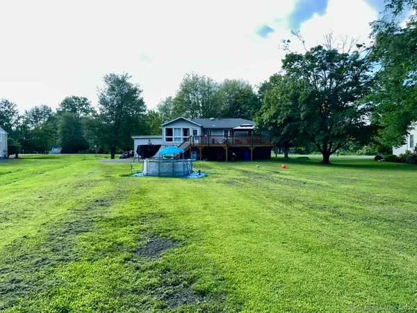 a view of a house with a yard porch and sitting area