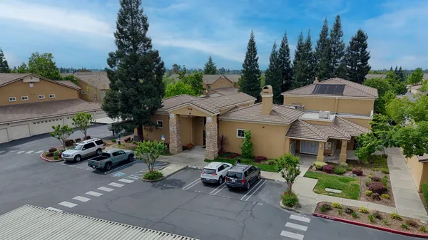 a view of a patio with plants and chairs and potted plants
