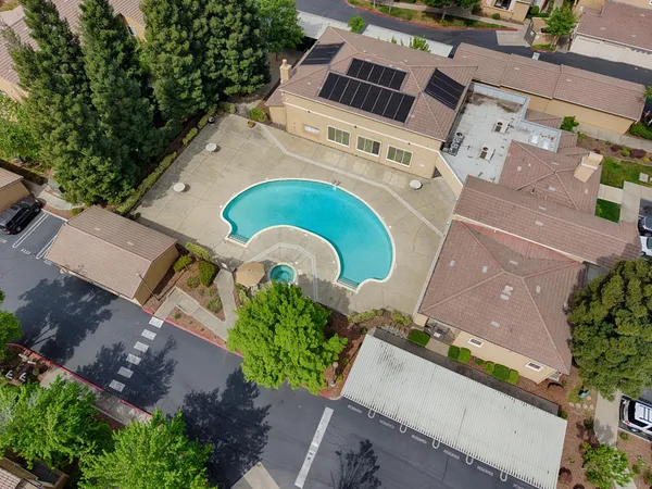 an aerial view of a house with a swimming pool
