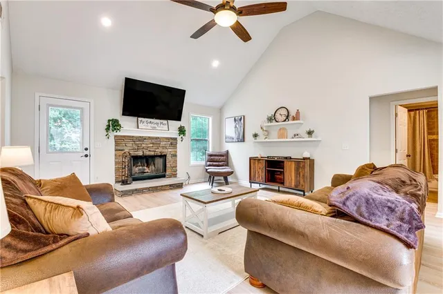 a living room with furniture a fireplace and a flat screen tv