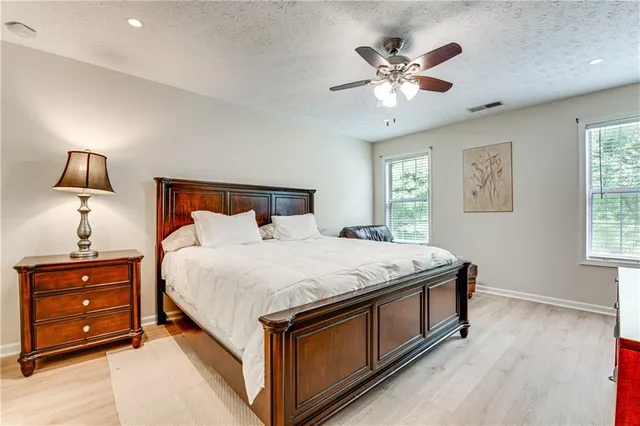 a bedroom with a bed and a night stand